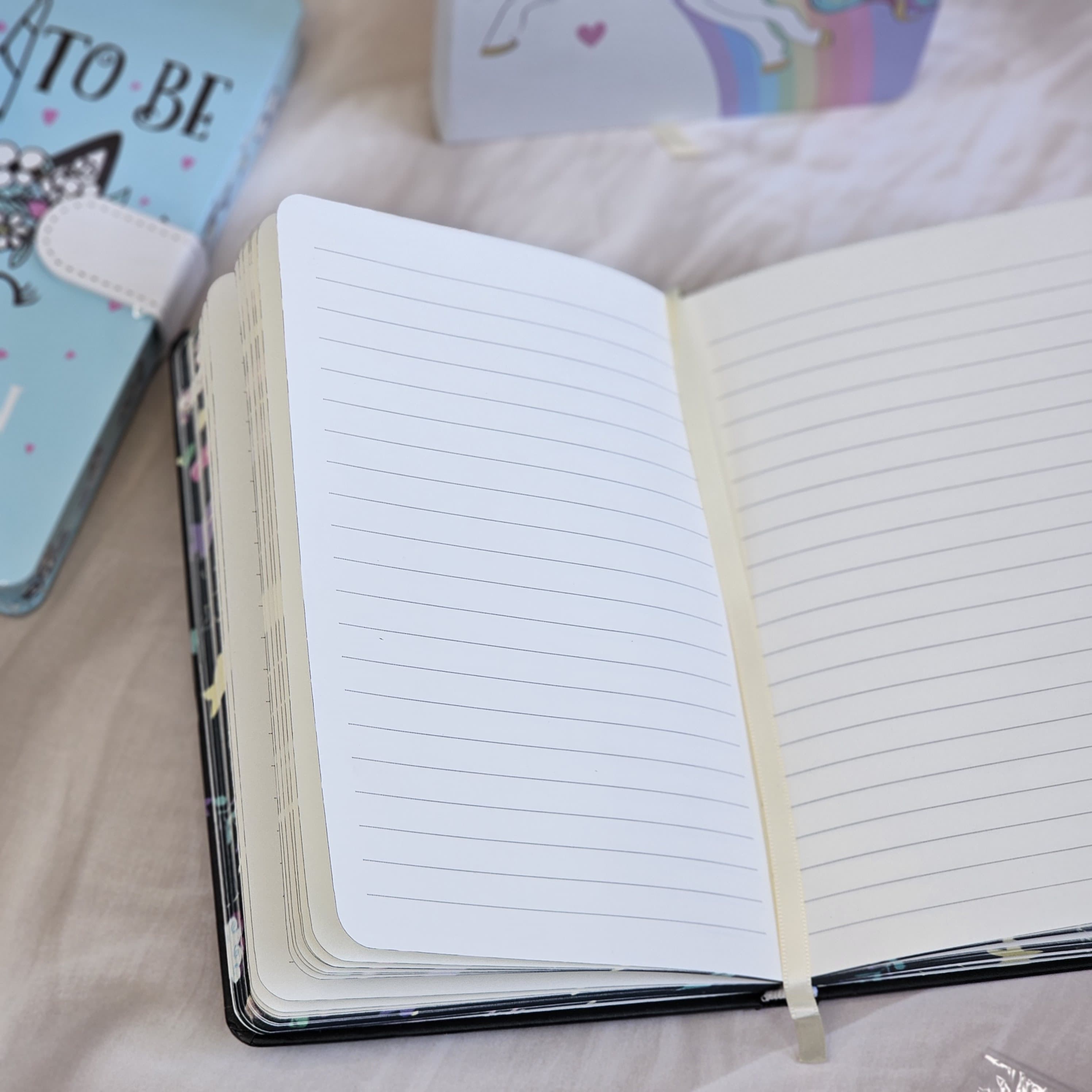 Four colorful pocket-sized diaries with unicorn illustrations, including a light blue diary that reads 'TIME TO BE A UNICORN', each with a clasp lock." www.usmile.toys